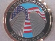 Front of special coin showing the American flag behind the twin towers