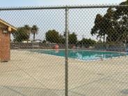 Swimming pool behind chain link fence