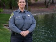 Female Code Enforcement Officer in front of a pond