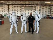 Three stormtroopers with Police Chief Mazer