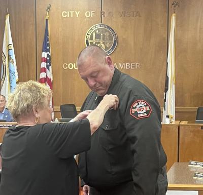 Ceremonial badge pinning of Chief Pfenning by his aunt