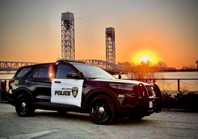 Rio Vista Police Car at sunset in front of the Helen Madere Bridge