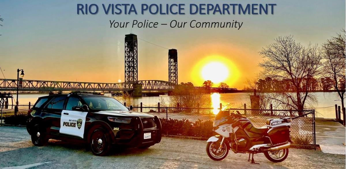 Rio Vista Police car and motorcycle in front of Helen Madere Bridge at sunset.