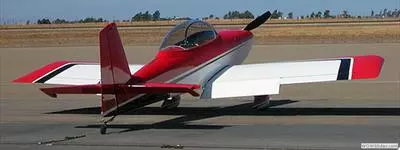 Red and white airplane on the ground