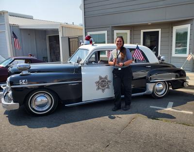 1950 Dodge police car with CAPS President & Support Services Manager Jen Torres