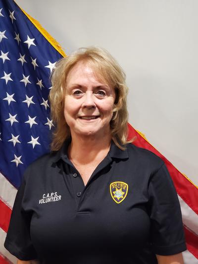 Female police chaplain in front of American flag